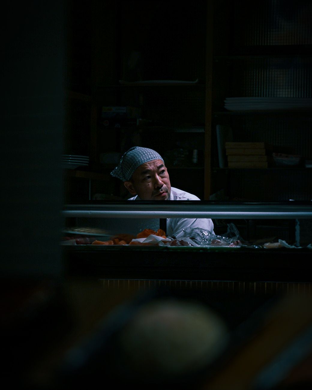 Japanese chef preparing sushi counter dish